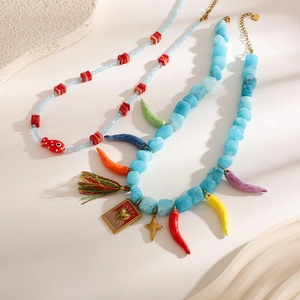 Detail of colorful chili charms and natural stone beads on a bohemian style necklace