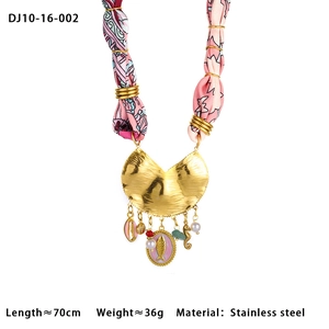 Detail of stainless steel scarf necklace with enamel charms and printed silk cord
