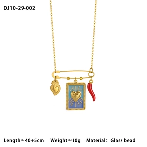 Detail of paperclip chain necklace with heart and chili pendants and LOVE charm