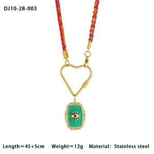 Détail du collier en corde tressée avec pendentif œil et fermoir cœur doré sur blanc
