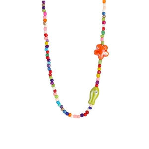 Colorful beaded necklace with orange flower and green fish charm on white background
