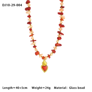 Close-up of colorful glass beaded necklace with golden heart pendant and red accent detail