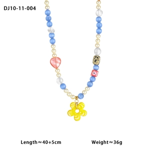 Detail view of colorful beaded necklace with yellow flower pendant and heart charms