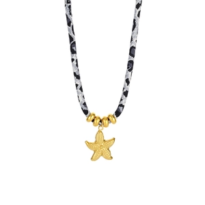 Close-up of golden starfish pendant with leopard print woven cord and gold beads