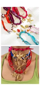 Detail of colorful silk scarf necklace with gold charms like starfish and shells