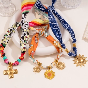 Detail of silk scarf wrapped necklaces with vintage metal pendants and beads