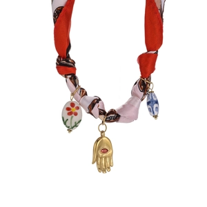 Detail of bohemian silk scarf necklace with Hamsa hand and ceramic beads pendants