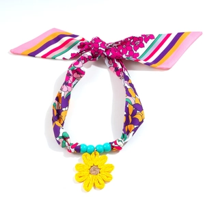 Floral print silk scarf necklace featuring blue beads and a yellow crochet sunflower charm