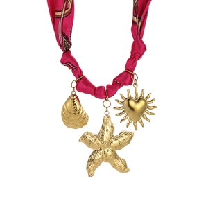 Detail of necklace with gold starfish, shell, heart charms and pink silk cord