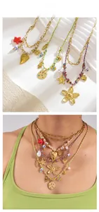 Gros plan de colliers bohèmes superposés avec pendentifs dorés et cordons tressés