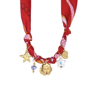 Detail of red floral scarf necklace featuring gold sun, shell charms and ceramic beads