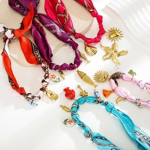 Bohemian satin hair scrunchies with assorted metal pendants including sun and shell charms