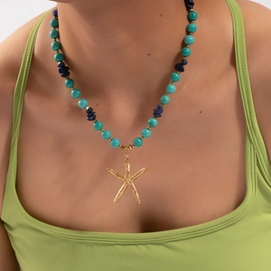 Beaded necklace with turquoise, lapis lazuli and gold starfish pendant on model