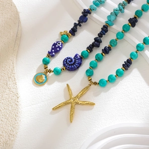 Ocean-themed beaded necklace with turquoise stones, sea star charms and gold shell pendants