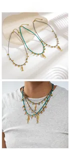 Detail of bohemian beaded necklaces with turquoise stones and golden fish pendants