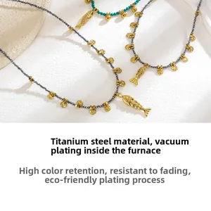 Detail of fish pendant necklaces featuring natural stones and gold-plated titanium steel