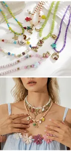 Colorful beaded ocean necklaces with shell charms and gold pendants shown on a model
