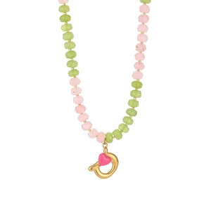 Detail of pink and green beads on a necklace with a gold heart charm pendant