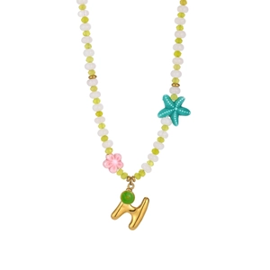 Detail of beaded necklace featuring ocean starfish charm and gold letter H pendant