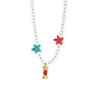 Detail of beaded summer necklace with starfish accents and strawberry charm on white background