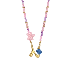 Detail of beaded ocean necklace featuring pink starfish, blue shell and a gold letter N