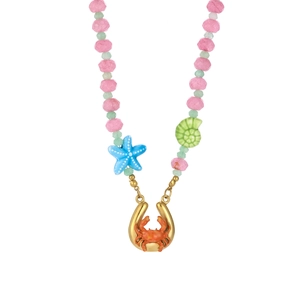 Detail of beaded ocean necklace with gold crab pendant, starfish and shell accents