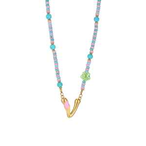 Detail of colorful beads with a gold V pendant featuring pink enamel for beach style