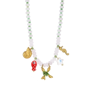 Detail view of marine pendants including seashell, fish and palm tree on beaded necklace