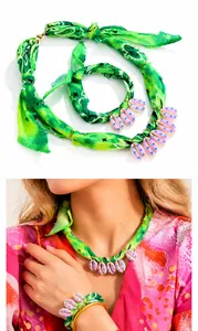 Detail of bohemian green paisley fabric jewelry set with pink shell-shaped pendants