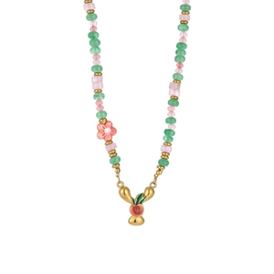 Detail of colorful beaded necklace with golden flower charm and sea style pendant