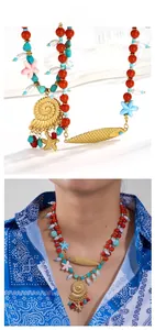 Détail du collier de perles avec turquoise et pendentifs de poisson doré sur un mannequin