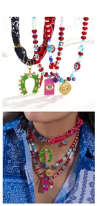 Detail of bohemian layered necklace with colorful beads, silk scarf and evil eye charms
