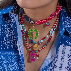 Bohemian layered necklace with horseshoe evil eye pendants and colorful beaded silk scarf