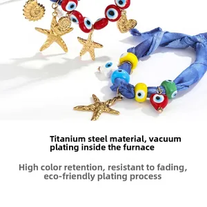 Detailed macro view of beach style silk scarf necklace with starfish and evil eye charms