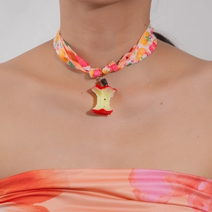 Close-up of vibrant floral neck scarf choker with unique resin apple core pendant