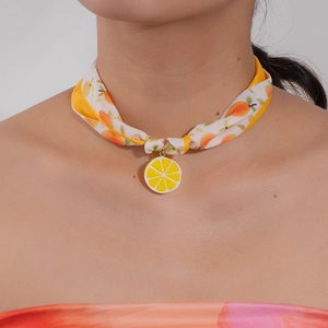 Summer style fabric choker with orange prints and a bright lemon slice pendant