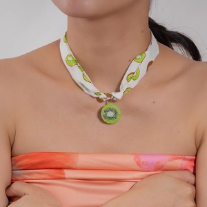 Detail showing kiwi slice resin pendant and fruit pattern silk scarf choker necklace