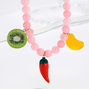 Colorful beaded necklace featuring kiwi, chili, and citrus fruit charms on pink beads
