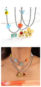 Detail of bohemian layered necklace with colorful charms and black and white seed beads