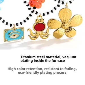 Macro detail of octopus and flower charms on a titanium steel beaded necklace