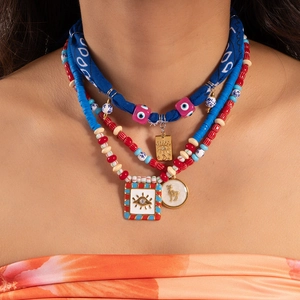 Boho layered necklace with evil eye enamel charm and colorful beaded strand details