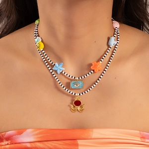 Double-layered beaded necklace with colorful ceramic charms like octopus and flowers