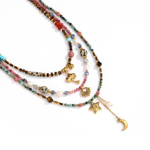 Bohemian multilayered beaded necklace with gold mushroom, evil eye, and star charms
