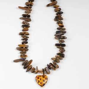 Detailed shot of tiger eye stone beads necklace with leopard print heart pendant
