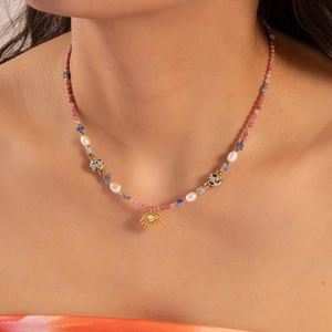 Handmade beaded necklace with mushroom stars and a golden evil eye pendant