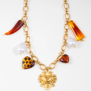 Detailed view of gold chain necklace featuring leopard print heart and sun medal pendants