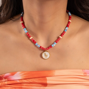 Colorful Evil Eye beaded necklace with a golden pendant charm for beach vacation style