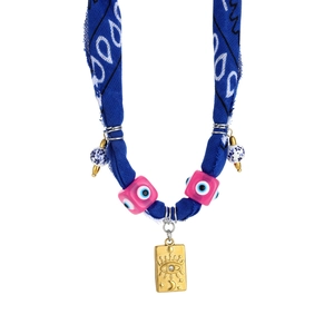 Close-up of bohemian blue bandana fabric necklace with evil eye beads and gold pendant