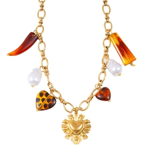 Vintage gold chain necklace with leopard heart, tiger eye stone, and sunburst pendant