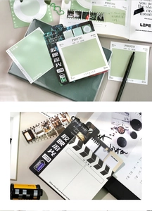 Macro-opname van filmstijl memoblokken met vintage cameraframes en kantoorbenodigdheden